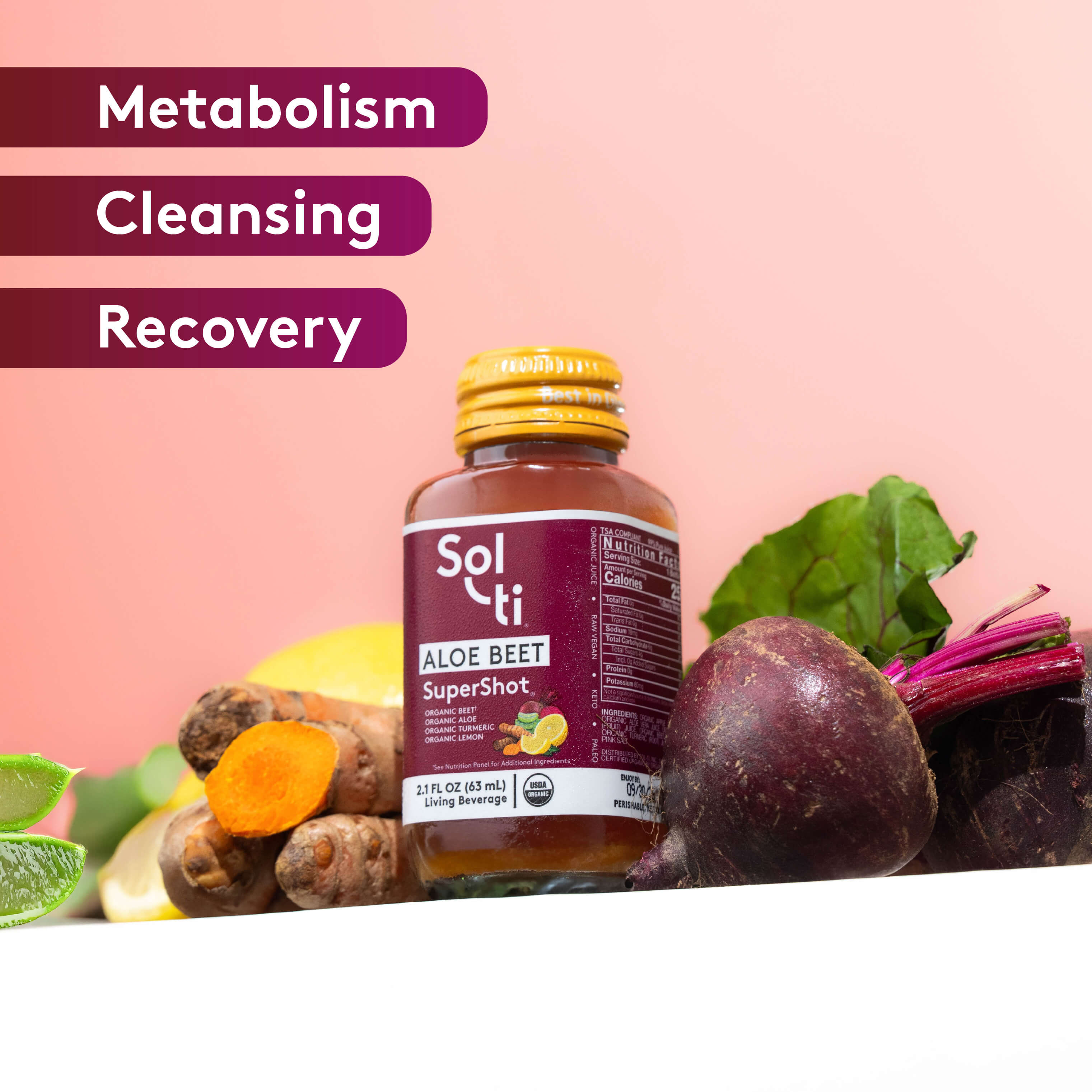 Sol-ti ALOE BEET SuperShot glass bottle with front label on light pink background, with turmeric root, beet root, lemon slice and aloe vera, benefits text including metabolism, cleansing, and recovery