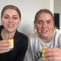 two women smiling are holding up Sol-ti SuperShots in their hands