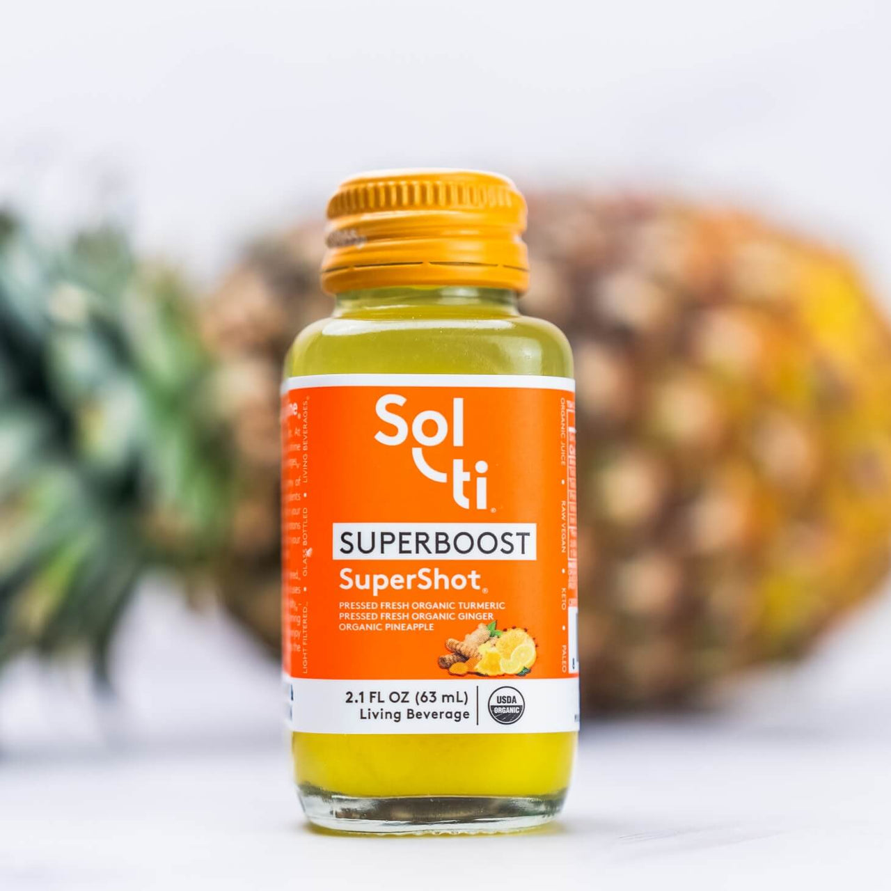 a bottle of SUPERBOOST SuperShot with a pineapple