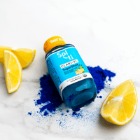 Thumbnail for a bottle of CLARI-TI SuperShot next to blue spirulina and lemon slices
