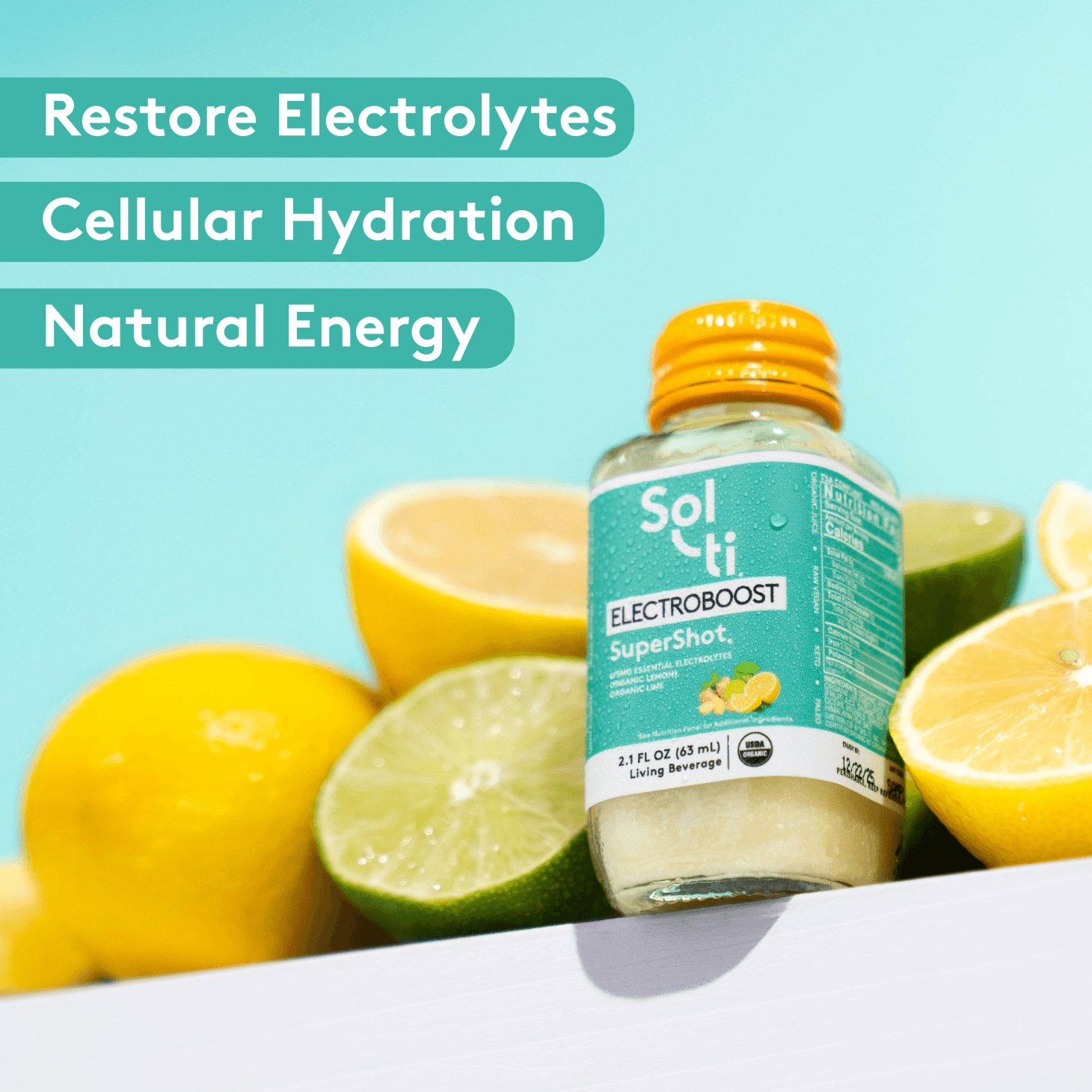 Sol-ti ELECTROBOOST SuperShot glass bottle with front label on light turquoise background, with lime and , lemon slice s, benefits text including restore electrolytes, cellular hydration and natural energy