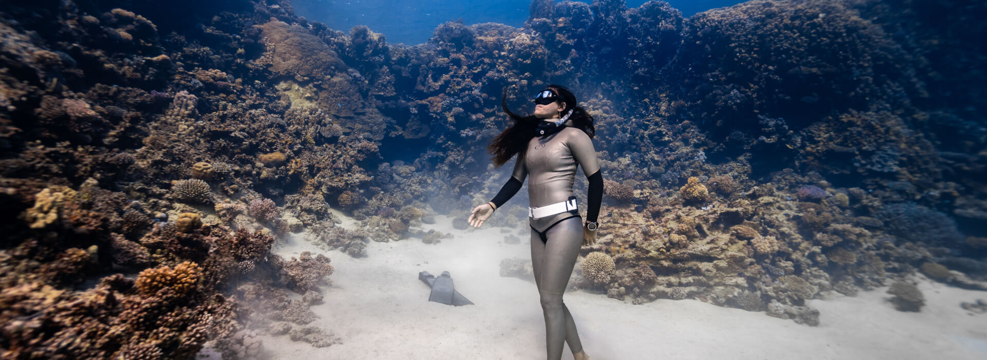 Enchante Gallardo scuba diving in an underwater coral reef setting