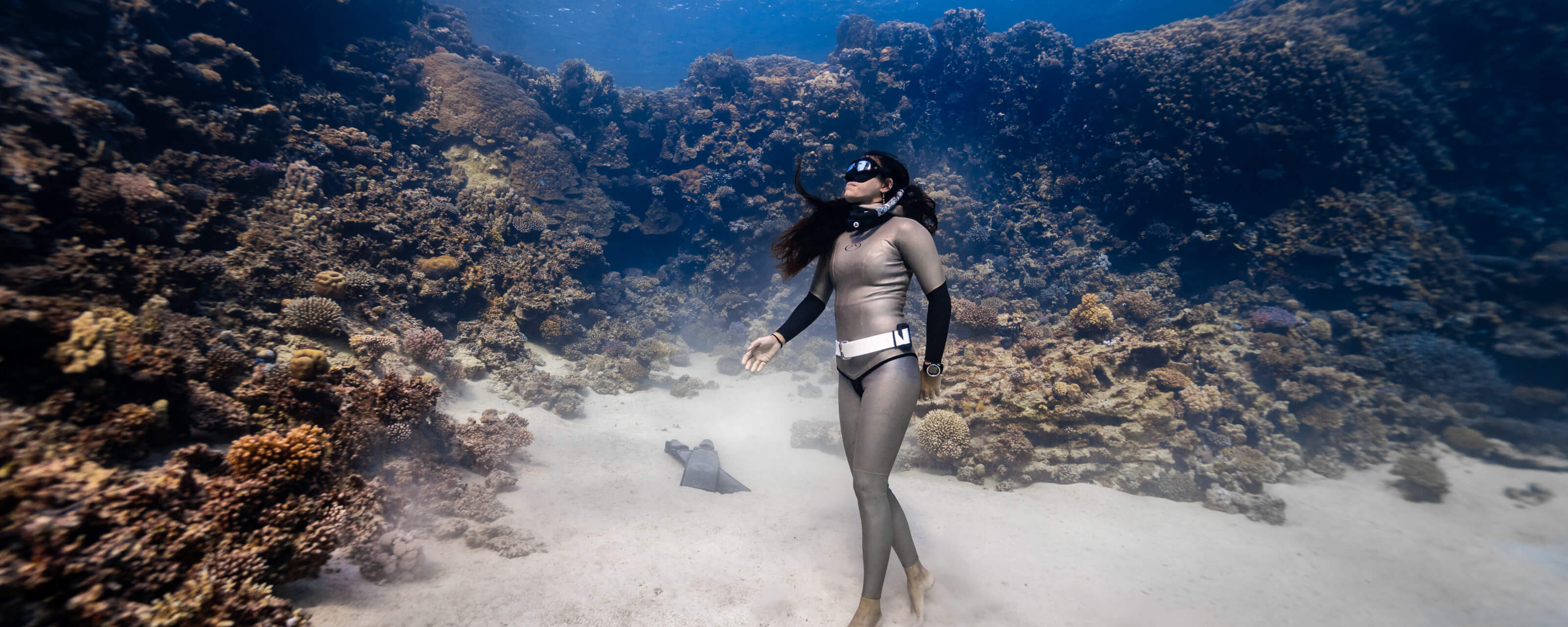 Enchante Gallardo scuba diving in an underwater coral reef setting