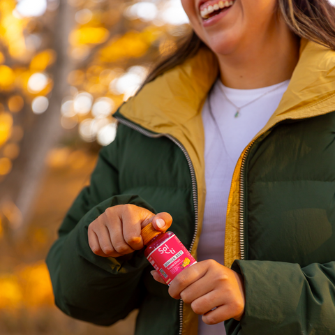 Sol-ti GINGER BEET SuperShot bottle held and opening, angled front label, warm background