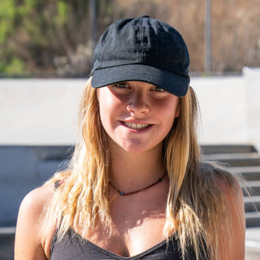 Katelyn West stands at a concrete skatepark 
