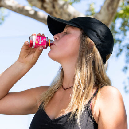 Katelyn West drinking GINGER BEET SuperShot bottle held in her hand