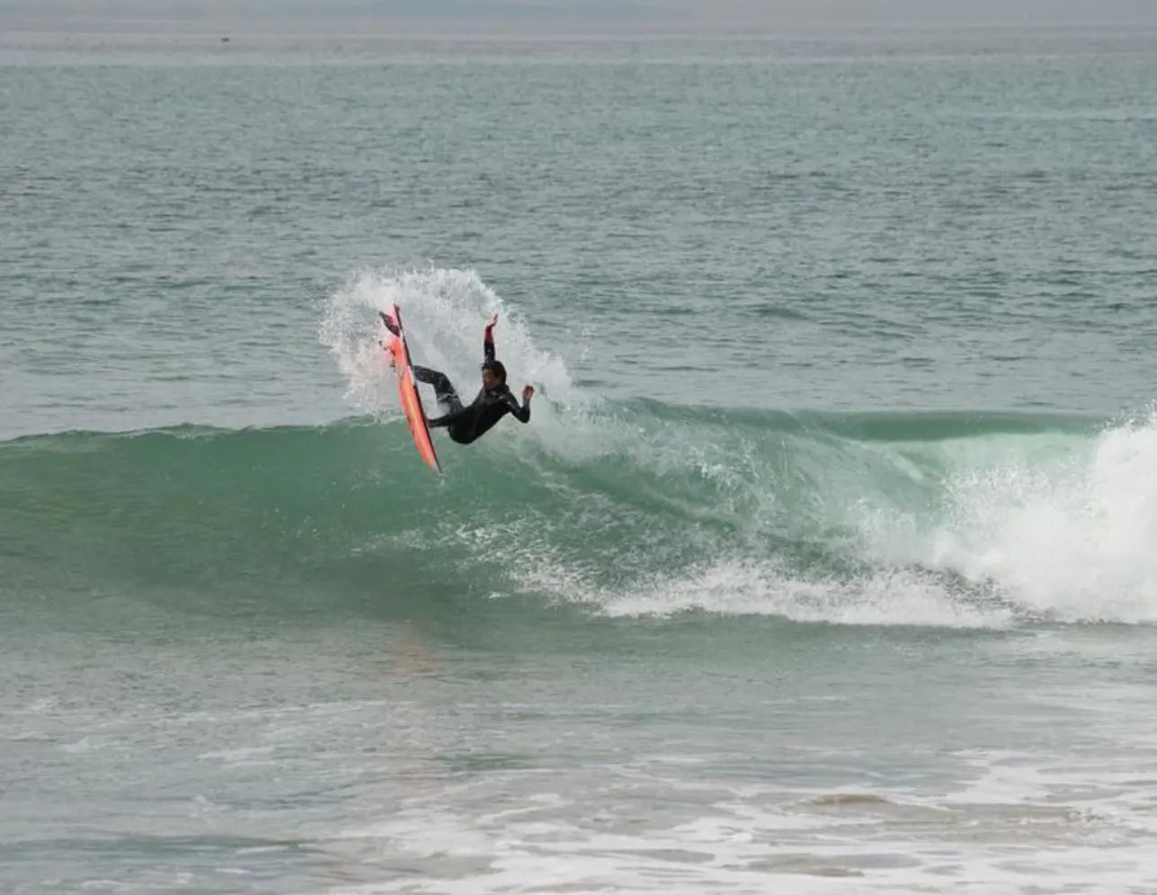 Kei Kobayashi rides a green ocean wave captured mid-air 