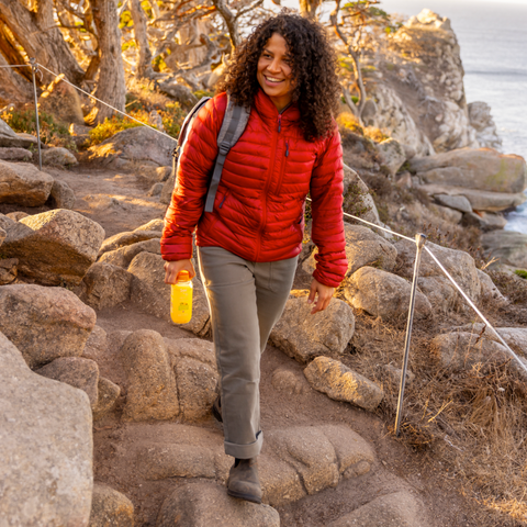 Person hiking holding Sol-ti Lemon Lime SuperAde bottle, front label, natural background