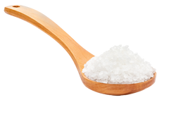 Wooden spoon filled with ocean minerals on a white background