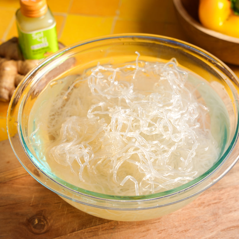 Clear glass bowl with Kelp Noodles on a wooden surface