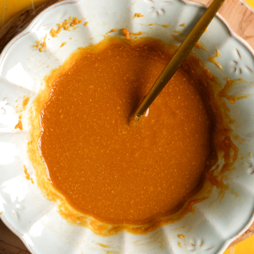 Peanut Sauce in a white container with a gold spoon