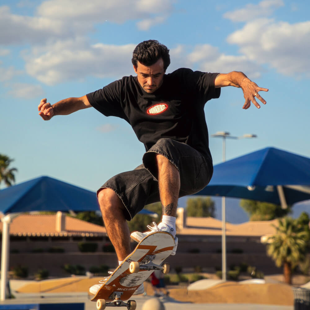Trevor McClung performing a skateboard trick in an outdoor skatepark 
